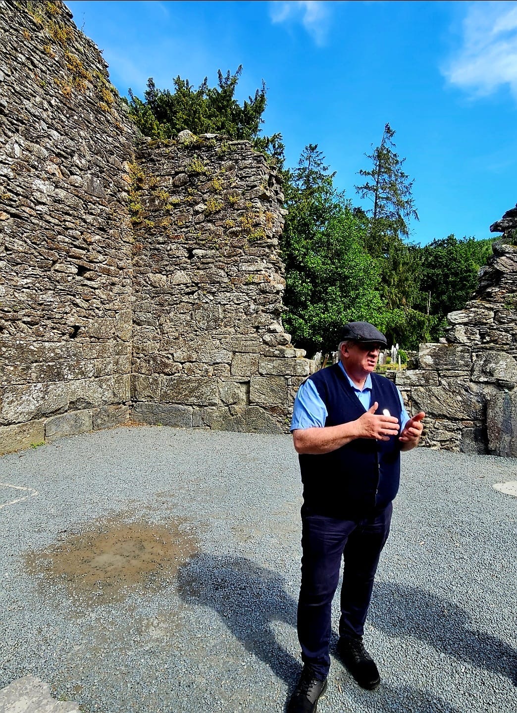 Ciarán Hayden speaking in a ruined monastery